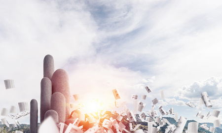 Image of high and huge stone columns located outdoors among flying papers with beautiful landscape on background. Wallpaper, backdrop with copyspace.の写真素材