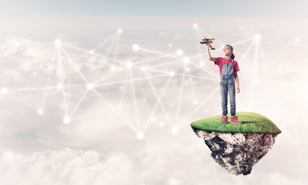 Cute smiling girl on floating island presenting social connection conceptの写真素材