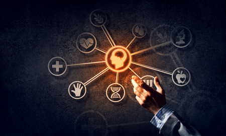 Businessman hand pointing on virtual screen over dark concrete backgroundの写真素材