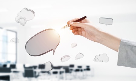 Close of woman designer working on glass chat bubble. Mixed mediaの写真素材