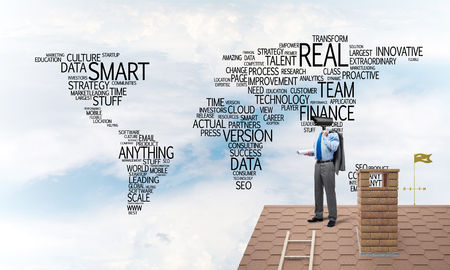 Faceless businessman with camera zoom instead of head standing on house roofの写真素材