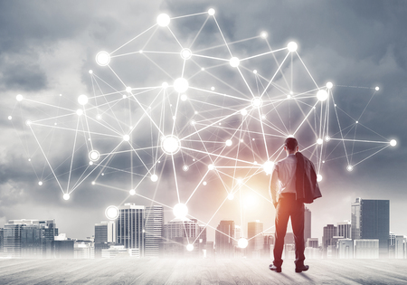 Businessman standing with back and looking at network drawn conceptの写真素材