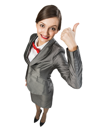 Top view of young cheerful businesswoman on white showing thumb upの写真素材