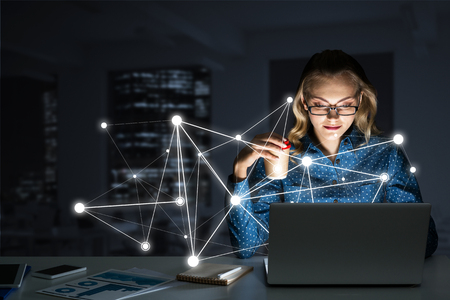 Smiling beautiful girl looking in glowing laptop screen. 3d renderingの写真素材