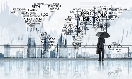 Back view of businessman with black umbrella looking at city. Mixed mediaの写真素材