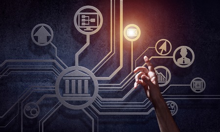 Businessman hand pointing on virtual screen over dark concrete backgroundの写真素材