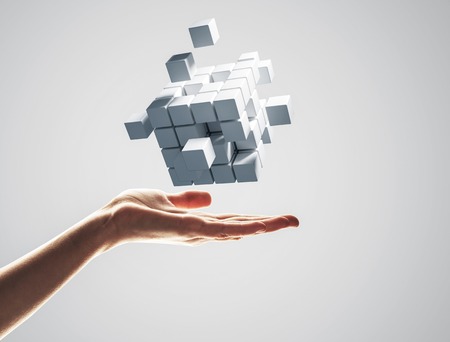 Close of businessman hand holding cube figure as symbol of innovation. 3D renderingの写真素材
