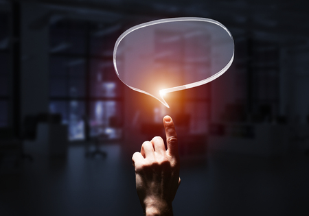 Close of businessman hands touching glass speech bubble as internet concept. Mixed mediaの写真素材