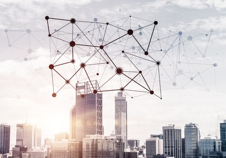 Modern cityscape with buildings and skyscrapers and social connection concept on screenの写真素材