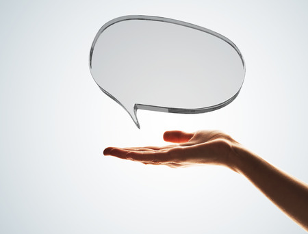 Close of male hand showing shiny glass speech bubble. 3d renderingの写真素材