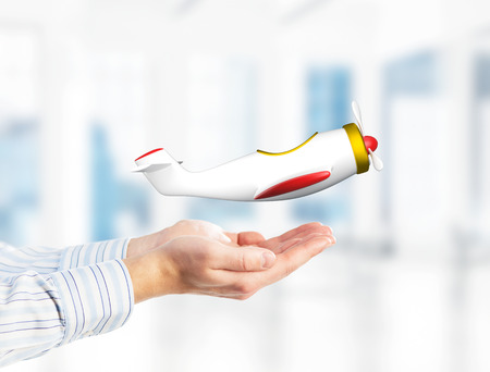 Close of businessman holding in palms retro plane model. Mixed mediaの写真素材