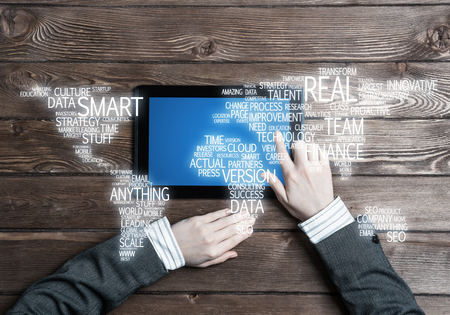 Top view of businesswoman sitting at table wooden with tablet pcの写真素材