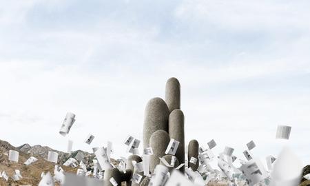 Image of high and huge stone columns located outdoors among flying papers with beautiful landscape on background. Wallpaper, backdrop with copyspace.の写真素材