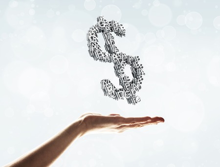 Close of businessman hand showing in palm cube made dollar signの写真素材