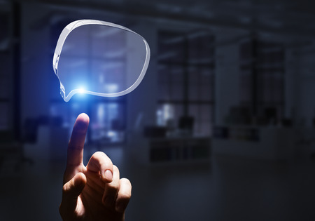 Close of businessman hands touching glass speech bubble as internet concept. Mixed mediaの写真素材