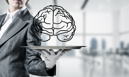 Cropped image of waitress's hand in white glove presenting sketched brains on metal tray with office view on background. 3D rendering.の写真素材