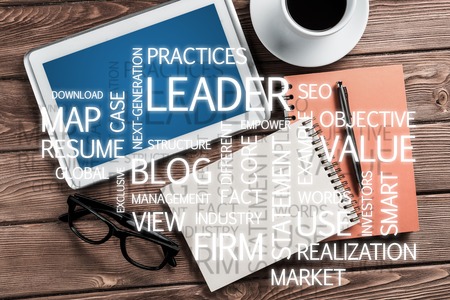 Top view of modern workplace with office stuff and business-related terms above presenting still office lifeの写真素材