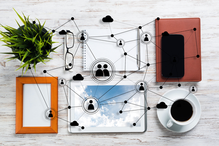 Top view of modern workplace with office stuff and social network connection above presenting still office life. Mixed media.の写真素材