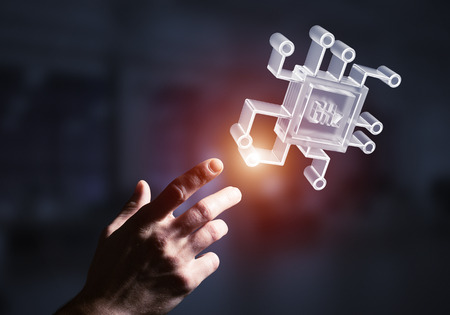 Close of businessman hand touching glass chip icon on dark office background. Mixed mediaの写真素材