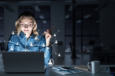 Beautiful girl looking in glowing laptop screen. 3d renderingの写真素材