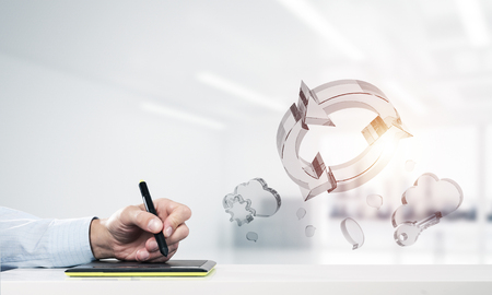 Close of man designer working on tablet device. Mixed mediaの写真素材