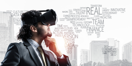 Young handsome businessman in virtual helmet against cityscape background