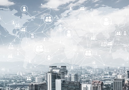 Modern cityscape with buildings and skyscrapers and social connection concept on screenの写真素材