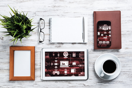 Top view of business workplace with tablet notepad coffee cup and other itemsの写真素材