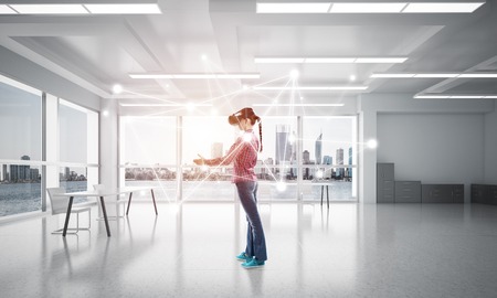 Young woman in casual wearing virtual helmet and working with connection concept. 3d renderingの写真素材