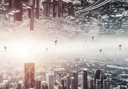 Abstract image of two modern urban worlds located upside down to each other with flying aerostats on the sky background. Wallpaper, backdrop with copyspace.の写真素材