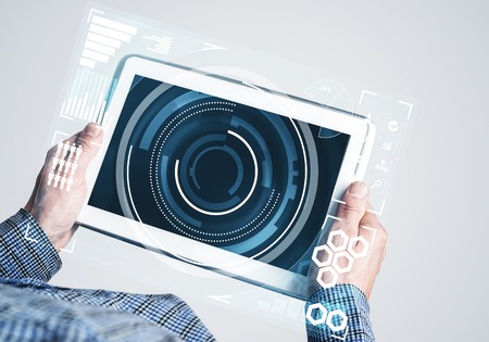 Digital world concept graphic on tablet screen in male hands