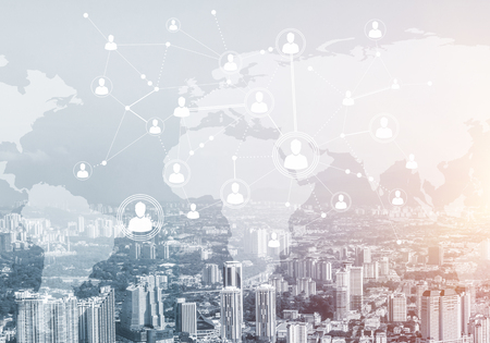 Modern cityscape with buildings and skyscrapers and social connection concept on screenの写真素材