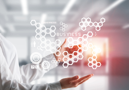 Closeup of business woman in shirt with business interface and media icons in her hands. Sunlight and office view on background. Mixed media.の写真素材