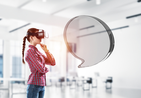 Woman in virtual helmet and glass speech bubble as internet concept. Mixed mediaの写真素材