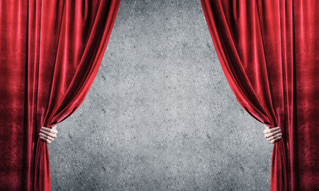 Close up of businessman hand open red velvet curtain. Place your textの写真素材