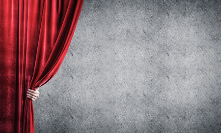 Close up of businessman hand open red velvet curtain. Place your textの写真素材