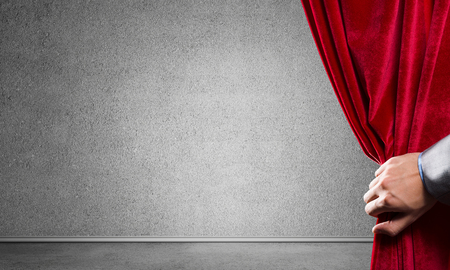 Close up of businessman hand open red velvet curtain. Place your textの写真素材