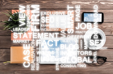 Top view of modern workplace with office stuff and business-related terms above presenting still...