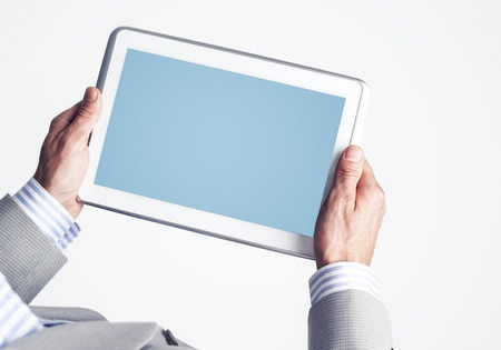 Close up of businessperson using digital tablet with blank displayの写真素材