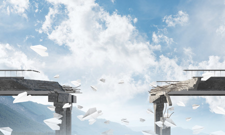 Broken concrete bridge with flying paper planes among high mountains and cloudly skyscape on background. 3D rendering.の写真素材