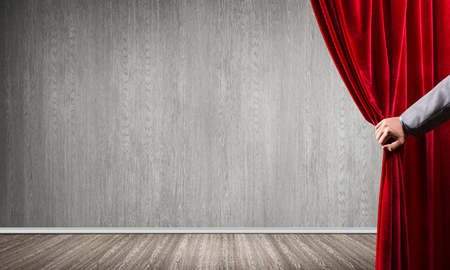 Close up of businessman hand open red velvet curtain. Place your textの写真素材