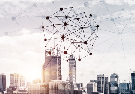 Modern cityscape with buildings and skyscrapers and social connection concept on screenの写真素材