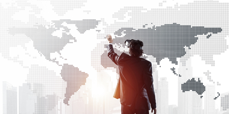 Young businessman in virtual helmet using media panel. Mixed mediaの写真素材