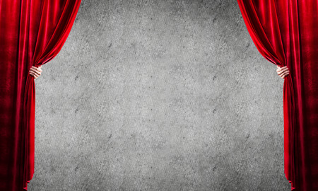 Close up of businessman hand open red velvet curtain. Place your textの写真素材