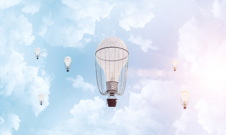 Colorful aerostats flying over the blue cloudy sky. 3D rendering.の写真素材