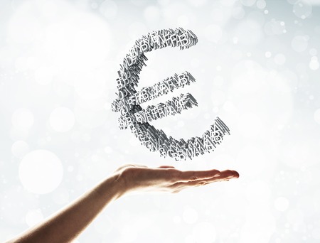 Close of businessman hand showing in palm cube made euro signの写真素材