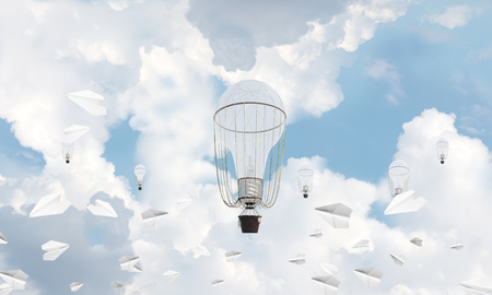 Colorful aerostats flying among paper planes and over the blue cloudy sky. 3D rendering.の写真素材
