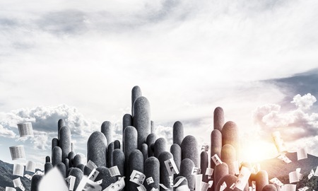 Image of high and huge stone columns located outdoors among flying papers with beautiful landscape on background. Wallpaper, backdrop with copyspace.の写真素材