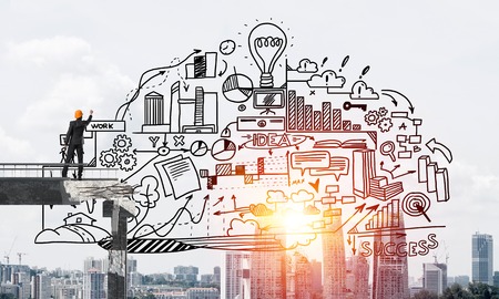 Businessman in helmet drawing business plan strategy while standing on broken bridge with cityscape and sunlight on background. 3D rendering.の写真素材