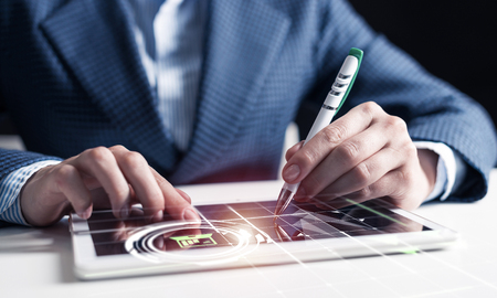 Businessman hands using tablet computer. Digital marketing media or financial diagrams in virtual screen. 3D chart floating above digital tablet computer screen. Modern smart technology in businessの写真素材